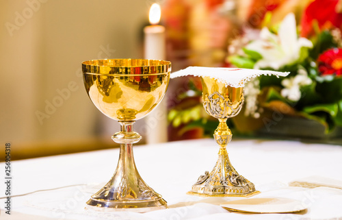 cup with wine and ciborium with host on the altar of the holy mass