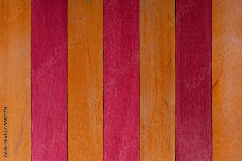 Beautiful texture of natural wood slats of orange and red colors. Natural and aged appearance.