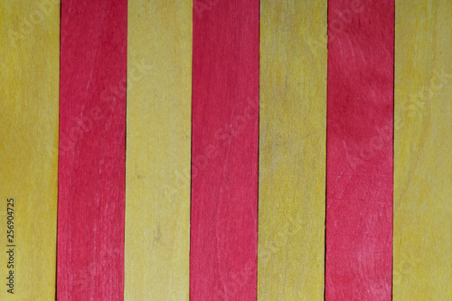 Beautiful texture of natural wood slats of red and yellow colors. Flag of Catalonia. Natural and aged appearance.