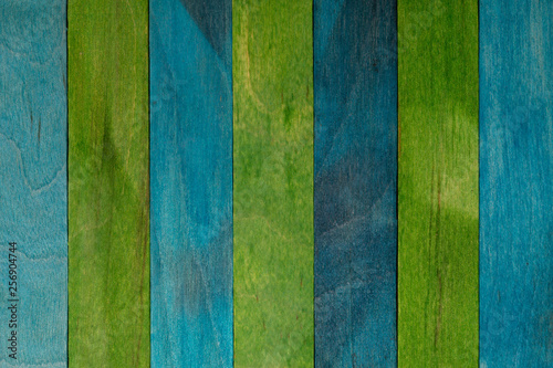 Beautiful texture of natural wood slats of blue (turquoise) and green colors. Natural and aged appearance.