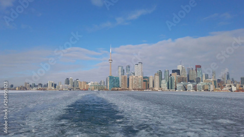 View of Toronto city skyline form a boat as it crosses the frozen Lake Ontario