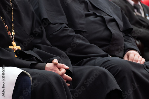Fototapeta Representatives of the Orthodox clergy in black robes sit in the conference hall