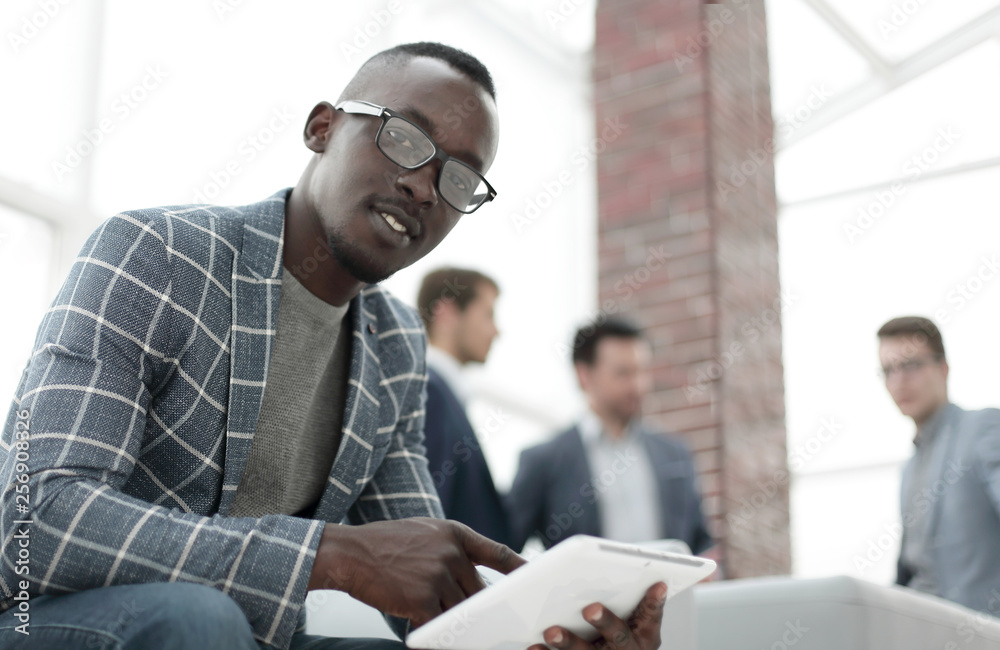 close up.a young businessman uses a digital tablet