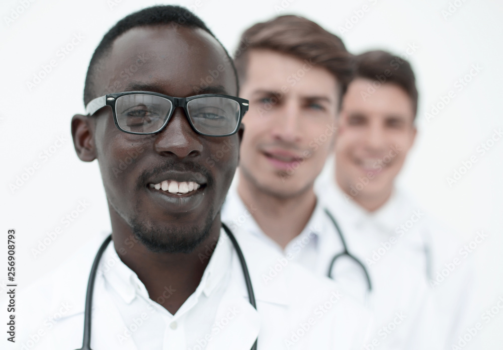 group of multi-racial doctors standing in a row group of multi-racial doctors standing in a row