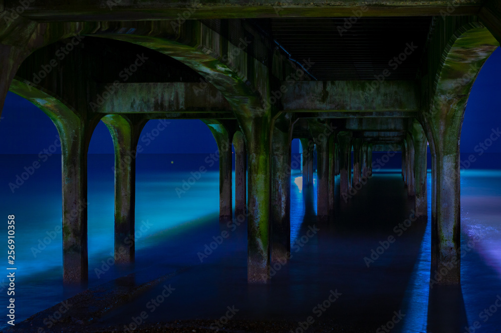 under Bournemouth pier at night with some moody editing