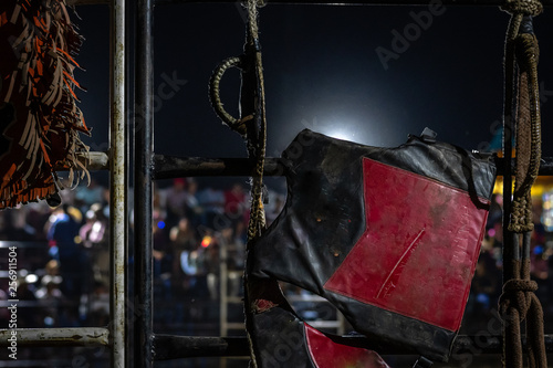bull riding gear on gate in Guatemalan rodeo photo