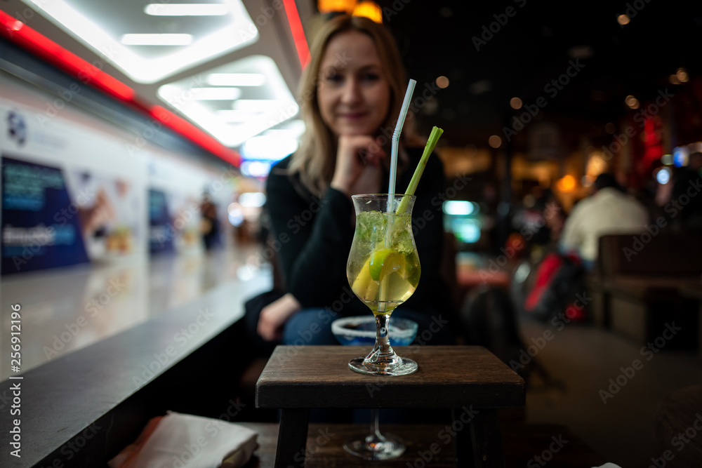 Cocktail with young caucasian girl in background