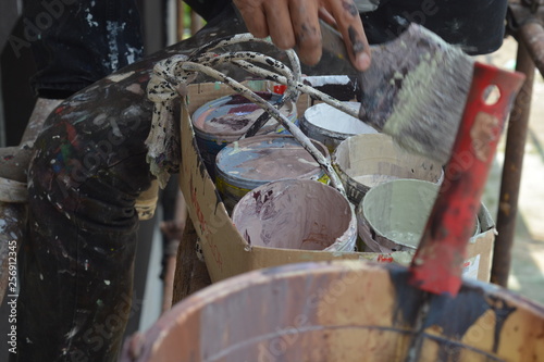 Man painting grafitti, colors and paint