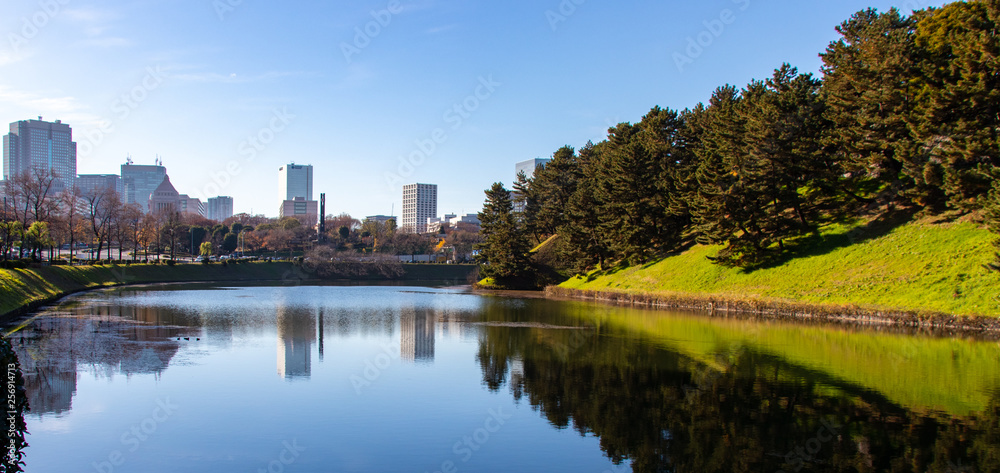 Moat in Tokyo Japan around Imperial Palace with trees and builings