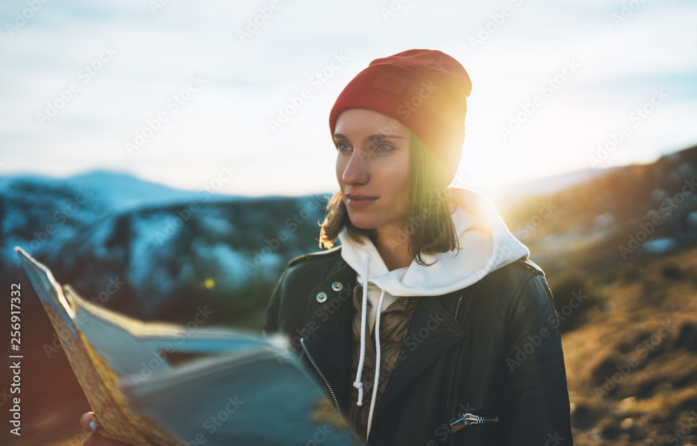 Fototapeta premium young girl look and hold in hands map, people planning trip, hipster tourist on background sun flare nature, enjoy journey landscape vacation trip, lifestyle holiday concept, sun mountain