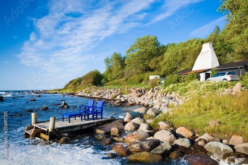 Wooden pier with chairs and...