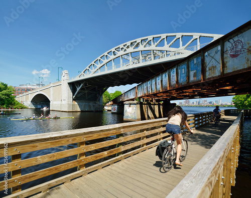 Woman Biking Under BU Bridge, Commuting In The City photo