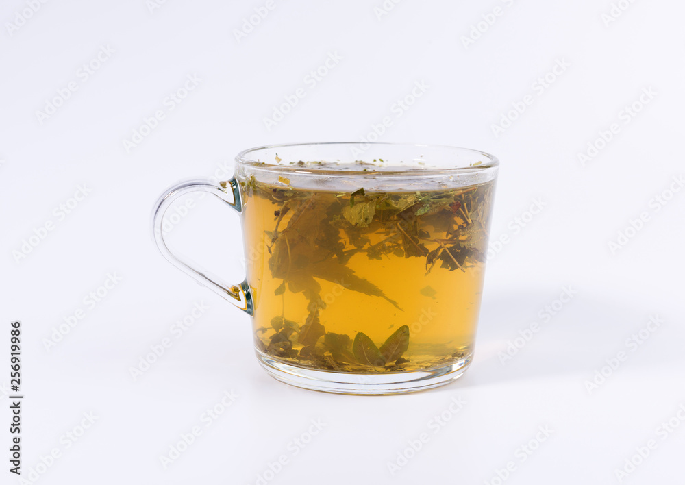 green herbal tea in a transparent cup isolated on white background green herbal tea in a transparent cup isolated on white background