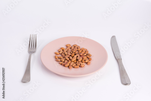 pile of beans on a plate isolated on white background