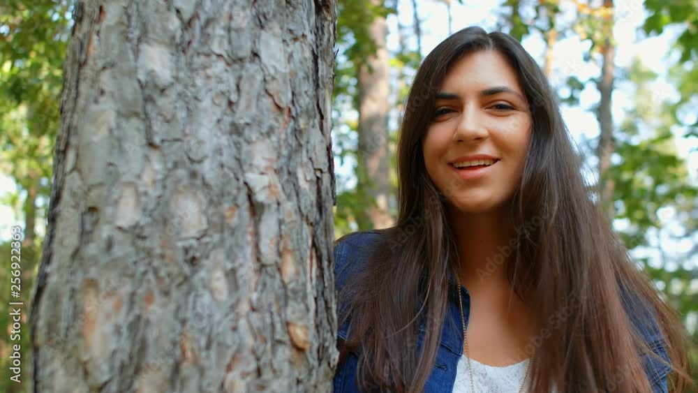 Portrait of beautiful brunette girl flirting with the camera in the park, 4k slow motion Portrait of beautiful brunette girl flirting with the camera in the park, 4k slow motion