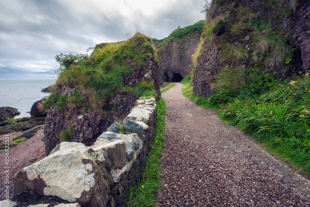 Path leading to the Cushendun Cave in Northern Ireland Path leading to the Cushendun Cave in Northern Ireland