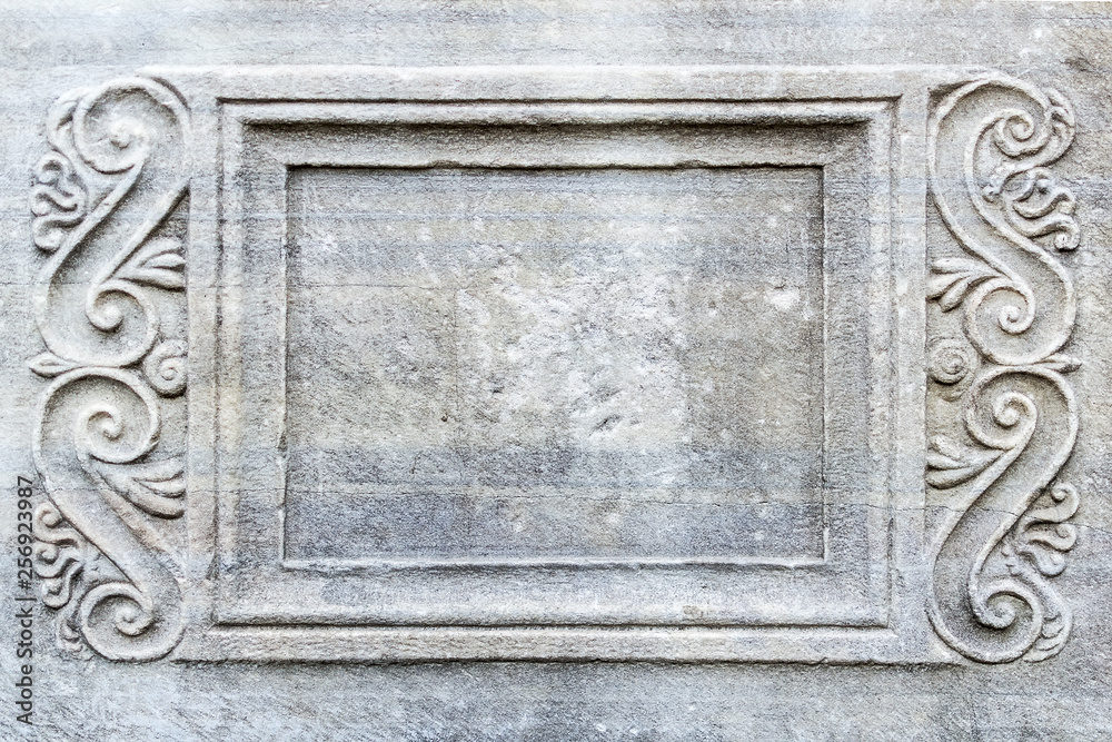 Close-up of rectangular frame with engraved ornament on ancient stone sarcophagus in a public park next to the Archaeological Museum in Varna.