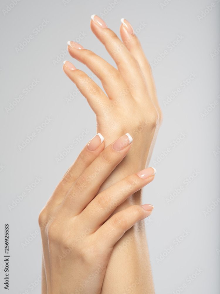 Woman gets manicure procedure in a spa salon. Beautiful female hands. Woman gets manicure procedure in a spa salon. Beautiful female hands.