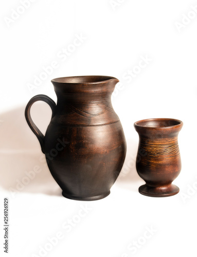 Pottery for drinks on white background..Brown pitcher with handle and bowl. Isolated objects.