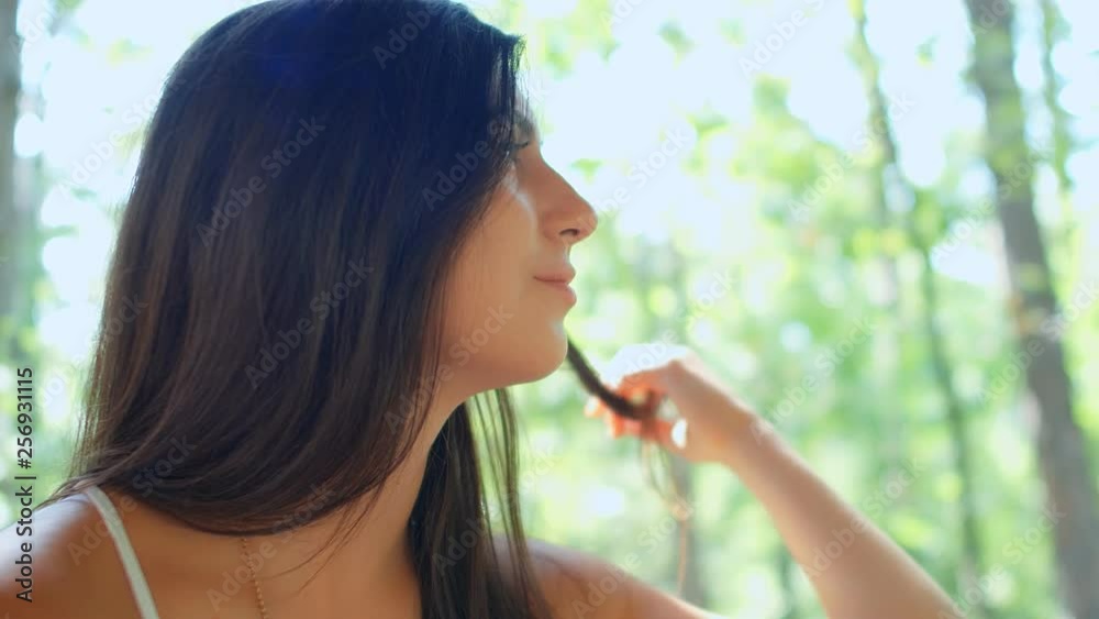 Portrait of beautiful brunette girl flirting with the camera in the park, 4k slow motion Portrait of beautiful brunette girl flirting with the camera in the park, 4k slow motion