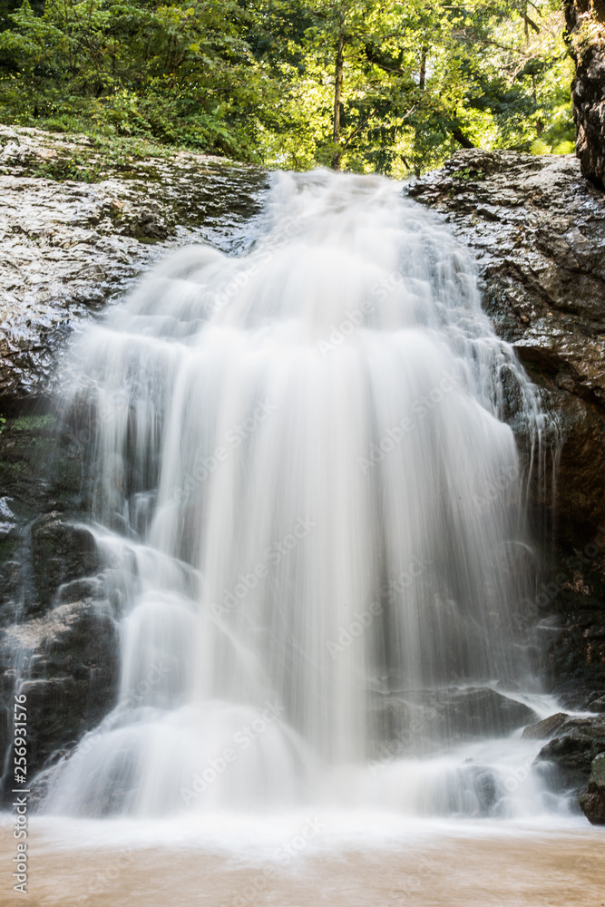 Fototapeta premium A valley with a waterfall . Russian nature near Sochi, Caucasus Mountains.