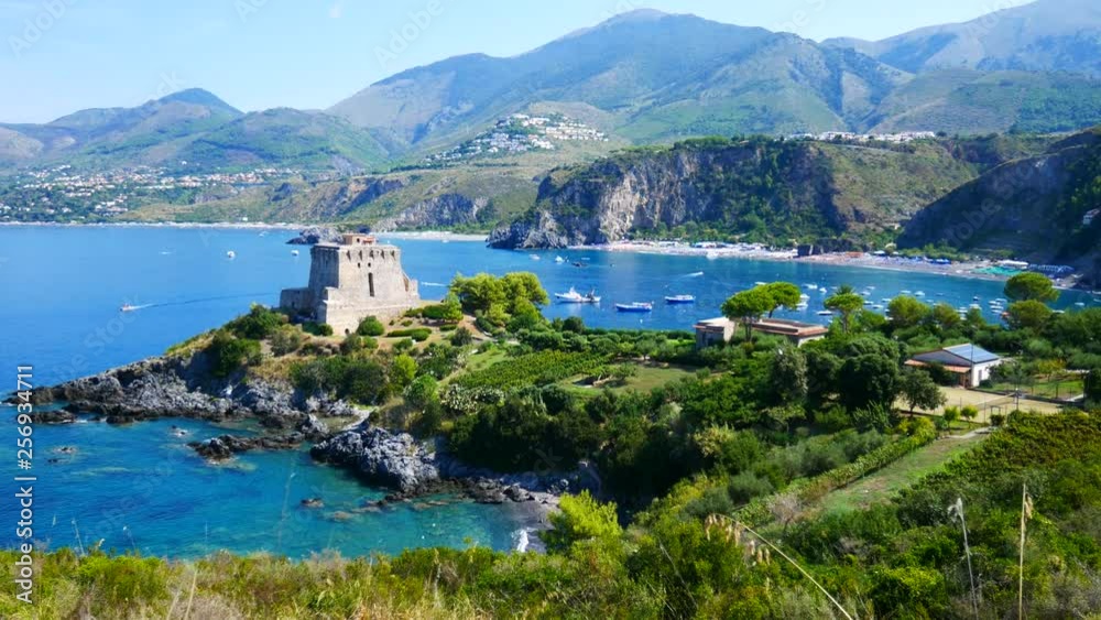 San Nicola Arcella, Calabria, Italy - September 6 2018: Dino island, Crawford tower (watchtower) and boats on Mediterranean sea (Tyrrhenian) San Nicola Arcella, Calabria, Italy - September 6 2018: Dino island, Crawford tower (watchtower) and boats on Mediterranean sea (Tyrrhenian)