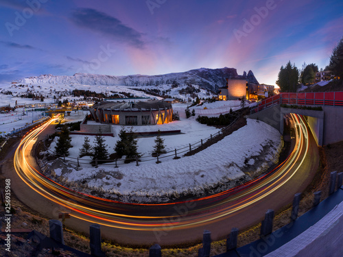 Beautiful modern hotel complex framed by street light trails in Seiser Alm, Italy
