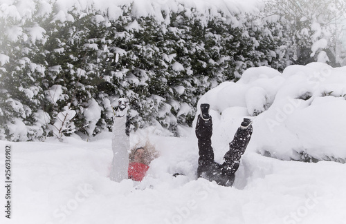 Mother and son jumping in deep snow  having fun