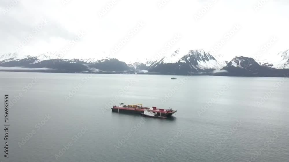 Tugboats and barges anchored up on Resurrection bay in Alaska Tugboats and barges anchored up on Resurrection bay in Alaska