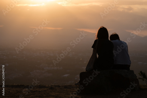 Couples sitting to watch the sunset