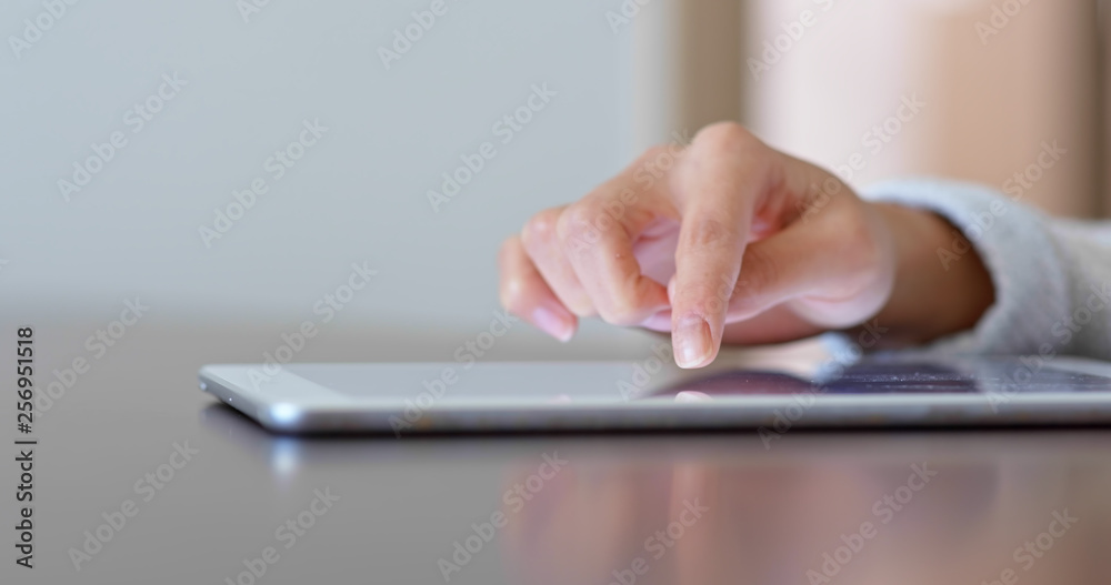 Woman finger touch on tablet computer at home Woman finger touch on tablet computer at home
