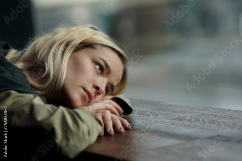 Woman absorbed  in thoughts looking out the window