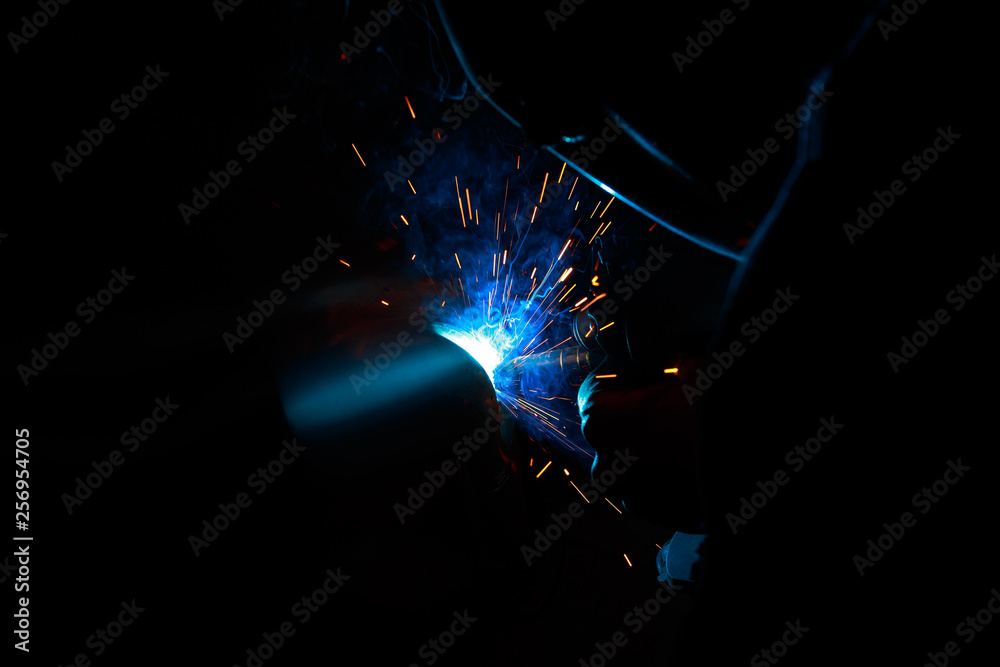 Arc welding. Welding of two metal plates in inert gases. MIG / MAG. A