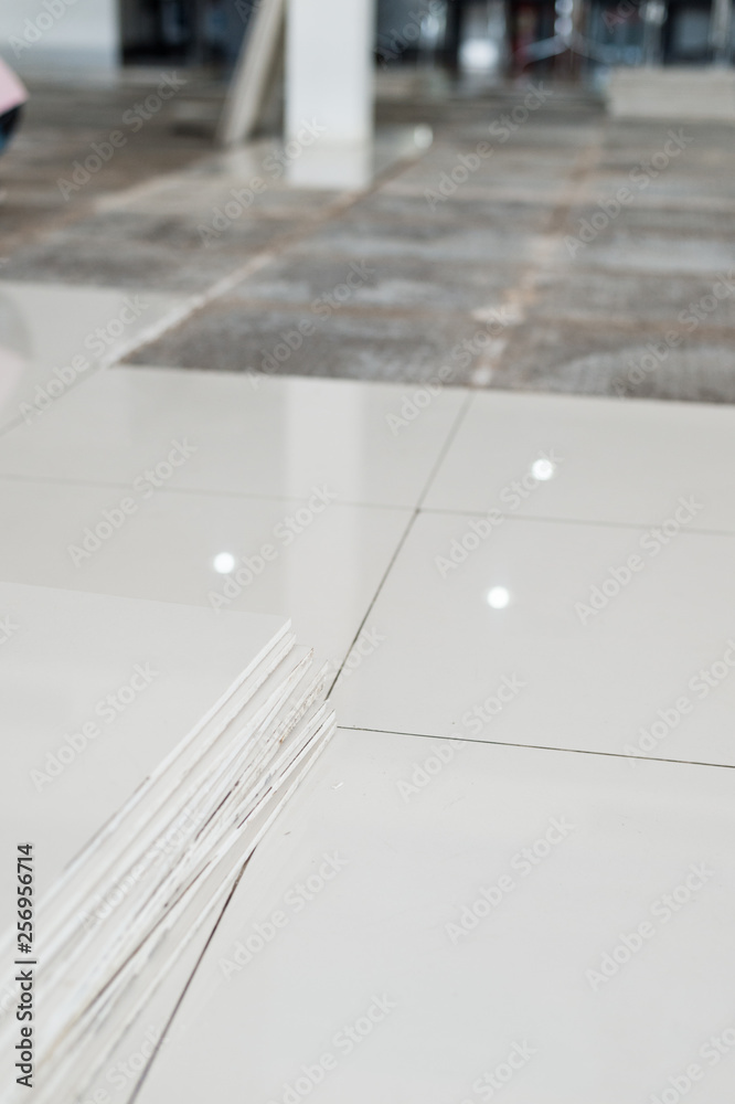 Ceramic tiles and tools for tiler. Floor tiles installation. Home improvement, renovation Ceramic tiles and tools for tiler. Floor tiles installation. Home improvement, renovation