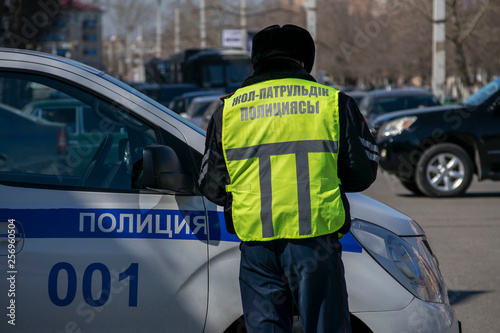 A patrol policeman is on duty. The inscription on the vest on the Kazakh 