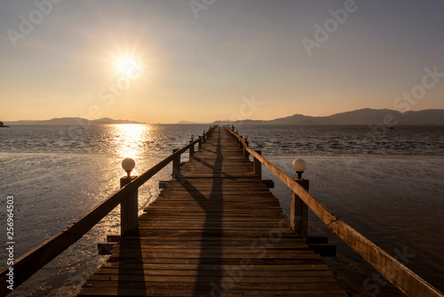 Summer Sunset on tropical beach  Wooden terrace dock or pier. Wooden dock  pier  blue sea and sky background at Andaman sea  Ranong estuary  Thailand  Vintage tone  Warm tone