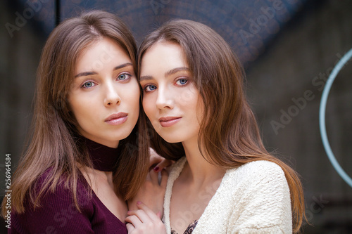 Two brunette young women, indoor © Andrey_Arkusha