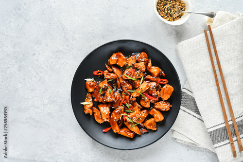 teriyaki chicken's  with  sesame seeds. spicy chicken in sweet and sour sauce with chili pepper. Chinese cuisine, copy space, recipe background, food flat lay, menu of japanese restaurant