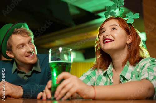 Red-haired pretty girl in a green checkered shirt looking romantic