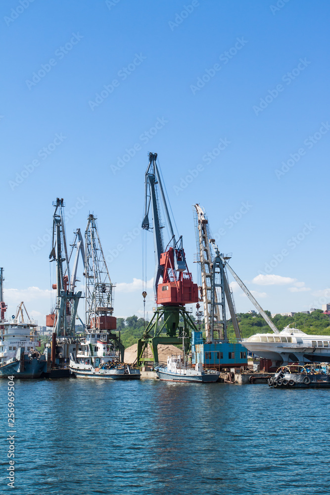 Ship Danube and high cranes at the river port.