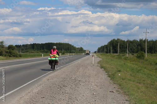 woman riding bicycle on country road