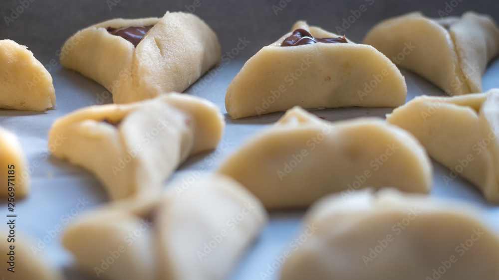 Preparing batch of hamantaschen for Purim Jewish Holiday- Israel Preparing batch of hamantaschen for Purim Jewish Holiday- Israel