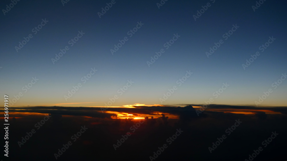 Photo of gorgeous tropical sunset taken from a plane window