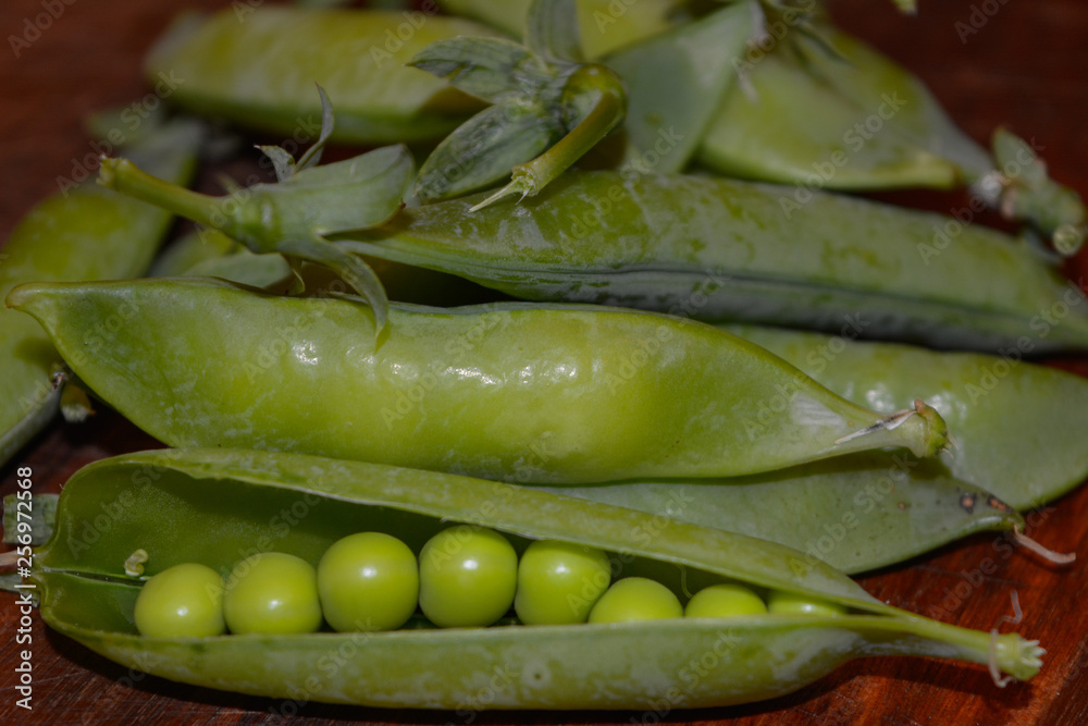 Fresh pea pods close-up on brown background Fresh pea pods close-up on brown background