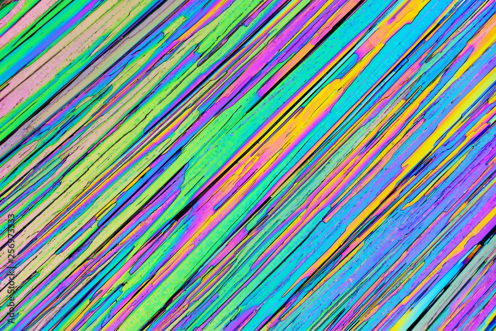 Colorful micro crystals in polarized light. Photo through a microscope. Colorful micro crystals in polarized light. Photo through a microscope.