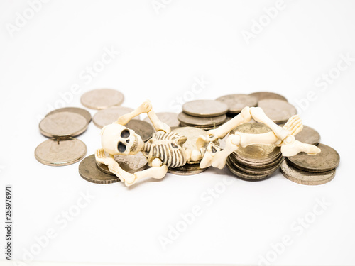 Skeleton laid on coins.