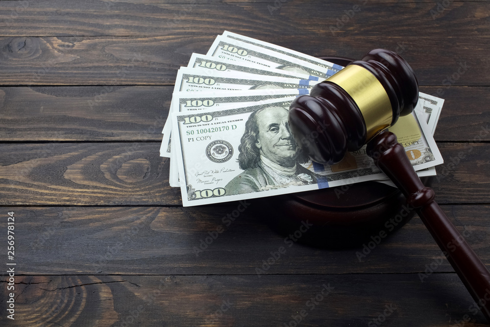 judge gavel and money on brown wooden table concept judge gavel and money on brown wooden table concept