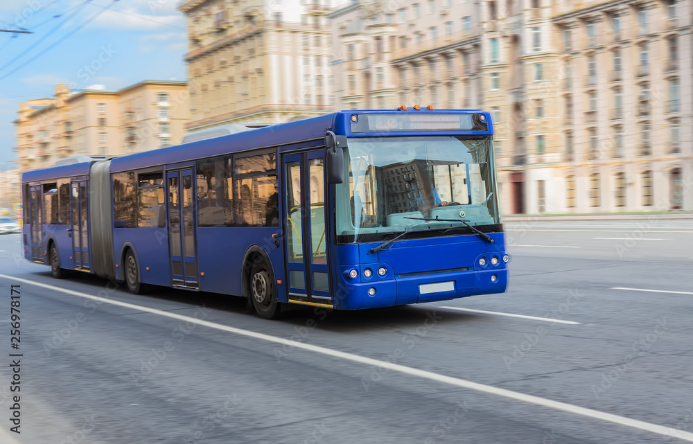 bus goes along street. blurred motion