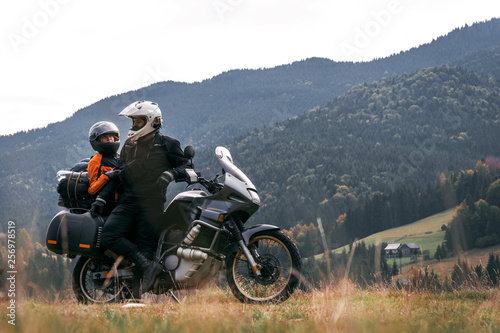 A loving couple on a touristic bike rides on a long journey together. travel, vacation. active lifestyle. View of the mountains and pine forest in the Carpathians Romania