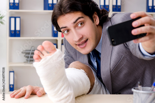 Leg injured employee working in the office